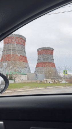 Striped cooling towers filmed from car in Cheboksary, Russia