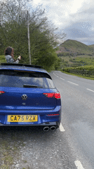 Couple documents roadside photo stop in Welsh countryside