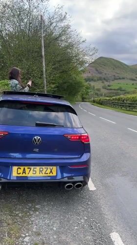 Couple documents roadside photo stop in Welsh countryside