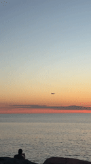 Aircraft spotted during sunset over water in Batumi, Georgia