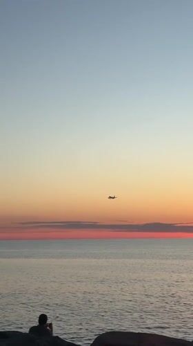 Aircraft spotted during sunset over water in Batumi, Georgia