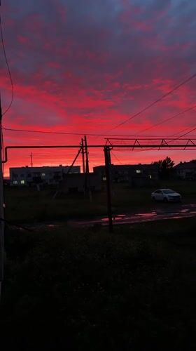 Vivid midsummer sunset lights up the sky over Mursalimkino