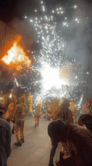 Fireworks and crowds in yellow at a Terrassa night event