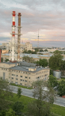 Saint Petersburg skyline at dusk, industrial smokestacks in frame