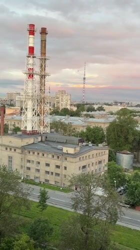 Saint Petersburg skyline at dusk, industrial smokestacks in frame