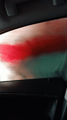 Inside a car wash — soap, brushes, and water on glass