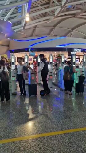 Travelers navigate airport security gates in Kuta, Indonesia