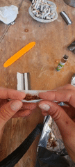 Person rolls cigarette by hand in Lachish region