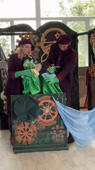Puppet show for kids, steampunk stage, purple-costumed performers