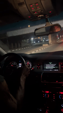 Night drive captured through Abuja streets under advertising overpass