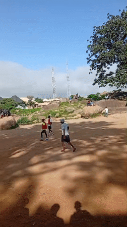Pickup soccer on rocky ground in Jos, Nigeria