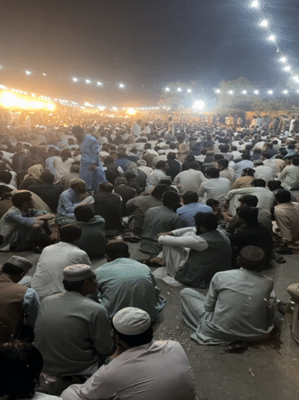 Nighttime outdoor gathering in Quetta draws large seated crowd