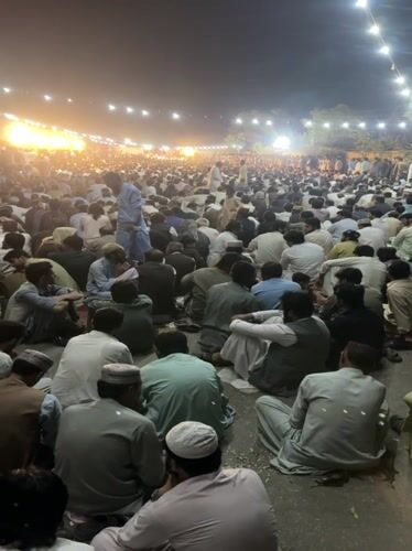 Nighttime outdoor gathering in Quetta draws large seated crowd