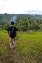 People gather on hillside overlooking Lhokseumawe, Indonesia