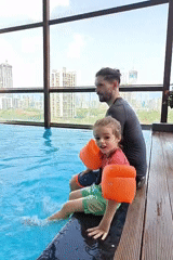 Father and child enjoy early morning swim session in Mumbai