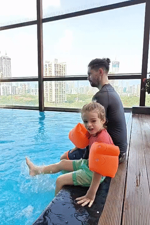 Father and child enjoy early morning swim session in Mumbai