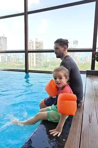 Father and child enjoy early morning swim session in Mumbai