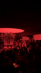 Woman dances on platform at crowded Thủ Đức nightclub
