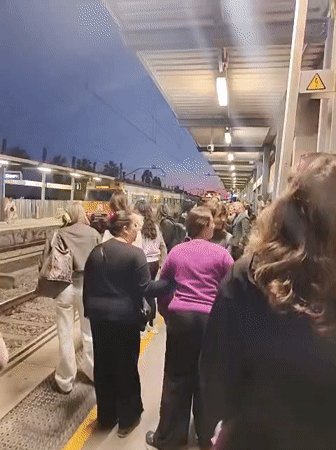 Evening rush hour crowds pack train at Canet de Mar