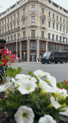 Tourist captures Budapest street scenes and landmarks during overcast afternoon