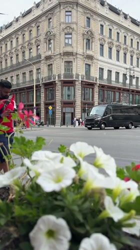 Tourist captures Budapest street scenes and landmarks during overcast afternoon