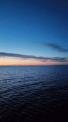 Twilight scenes captured over Russian waters show colorful sky transition