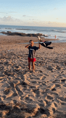 Boy flies homemade kite on Indonesian beach
