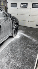 Black Toyota RAV4 getting washed at a Chișinău driveway