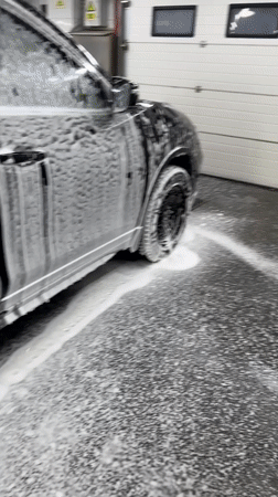 Black Toyota RAV4 getting washed at a Chișinău driveway