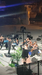 Fire, orchestra, and live painting collide at a Scordia night performance.