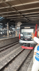 Train arrives at East Jakarta station with security present
