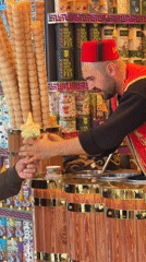 Traditional Turkish ice cream vendor serves customers in Istanbul