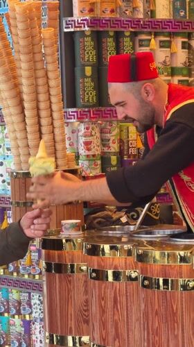 Traditional Turkish ice cream vendor serves customers in Istanbul