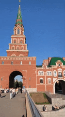 Tourist documents Yoshkar-Ola landmarks during sunny afternoon walkabout