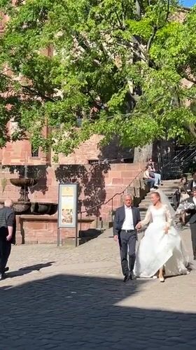 Wedding celebration and tourist activity documented in historic Heidelberg