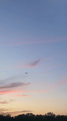 Helicopter filmed crossing sunset sky over Krasnoyarsk, Russia