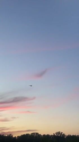 Helicopter filmed crossing sunset sky over Krasnoyarsk, Russia