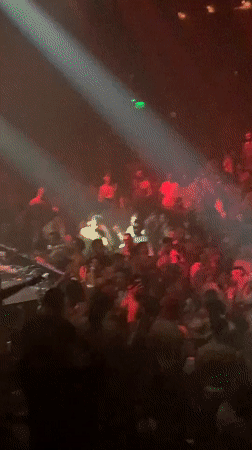 Late night Tel Aviv club scene with dancing crowds