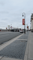 Pedestrians cross busy street in overcast Saint Petersburg
