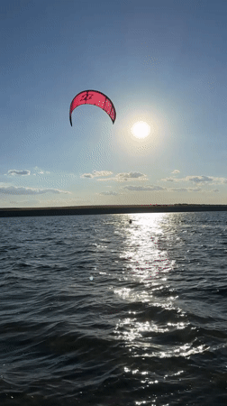 Kitesurfing and swimming on the Kyiv Reservoir, summer afternoon