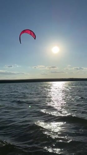 Kitesurfing and swimming on the Kyiv Reservoir, summer afternoon