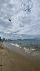 Kitesurfers hit Nha Trang beach on a cloudy morning