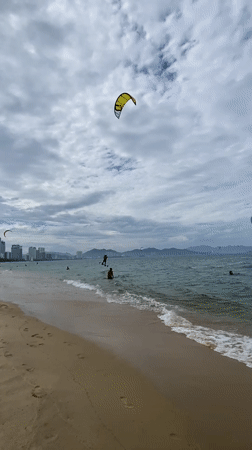 Kitesurfers hit Nha Trang beach on a cloudy morning