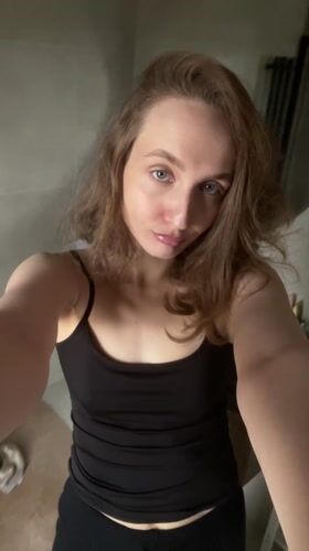 Woman takes mirror selfies in Podshivalovo, Russia apartment