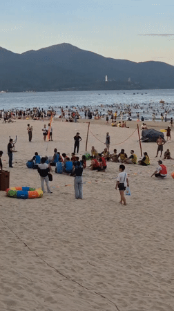 Da Nang beachfront busy with swimmers, walkers, and exercisers