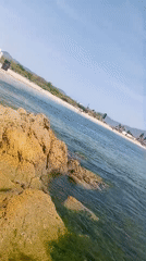 Relaxed afternoon at a rocky coastal swimming spot.