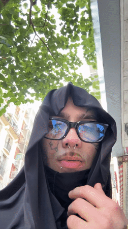 Hooded figure with piercings photographed in Buenos Aires