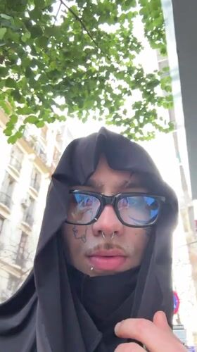 Hooded figure with piercings photographed in Buenos Aires