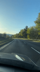 Driver travels rural two-lane road during late afternoon hours