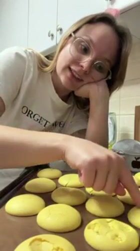 Woman bakes yellow macarons in Tel Aviv kitchen
